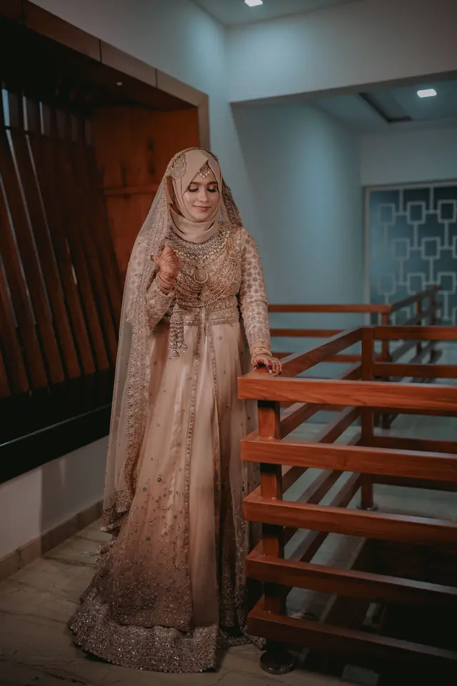 Bride in an ivory embellished gown and hijab, styled at Popyz Beauty Lounge, Kozhikode