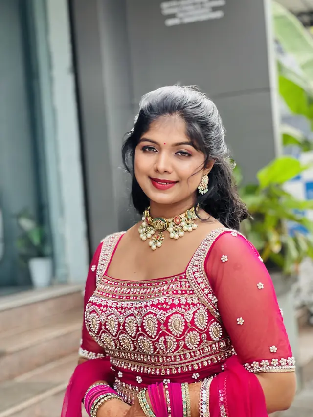 Bride in a fuchsia embroidered lehenga with a choker set