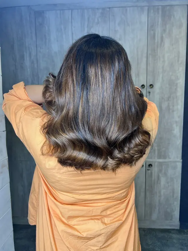 Back view of glossy, smooth brown hair in soft waves
