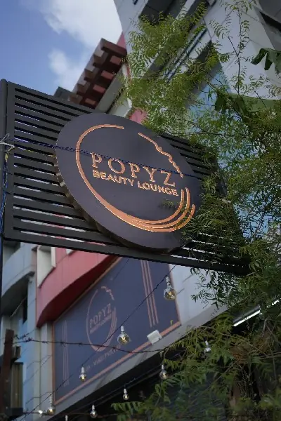 Popyz Beauty Lounge signboard at the entrance on Gandhi Road, Kozhikode